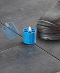 Proleveling System 1/32 Inch Extra Linear Leveler Stems Pack Of 100 for tile installations on black tiles with foot shown