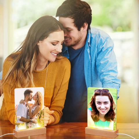 Couple enjoying photos in Six Pack Sublimation LED Photo Frames With Wood Stand 5 By 7 Inch USB Powered Night Lights Blank Frames
