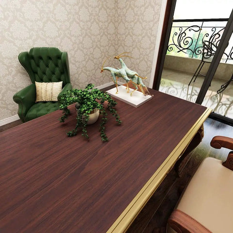 Slick Peel And Stick Countertop Wrap Featuring Sweet Dark Walnut Wood Grain on desk with plant and decor in elegant room.