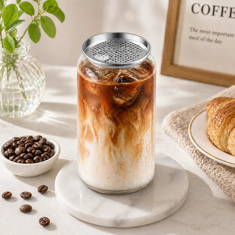 Clear 11oz Plastic Can Cup with Aluminum Lid, filled with iced coffee, on marble coaster, for automatic seaming machine.