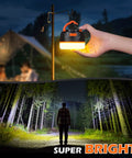 Hand holding Rechargeable Go To Camping Lantern With 6400mAh Battery For Long Runtime IPX5 Waterproof Tent Light shining in forest