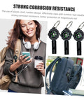 Three Pack Survival Whistles Keychain With Directional Indicator For Outdoor Emergency Use attached to backpack.