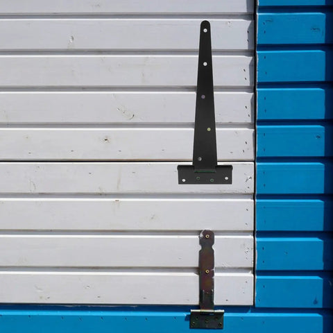 Heavy Duty Black Iron T Shape Gate Hinge Set With Slotted Bearing Design 12 Inch Extended Tee Hinge on white wooden gate