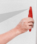 Person using FewNvWa Handheld Stud Finders for Wall Metal Detection in Wood And Drywall, Red on textured white wall.