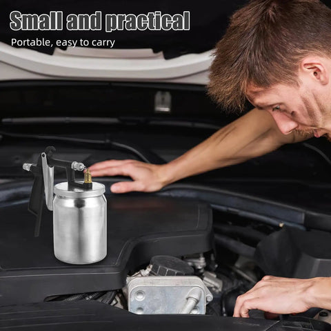 Real Deal Pneumatic Paint Sprayer With Tough Metal Housing for Slick Furniture Finishing and Car Refinishing on car engine.