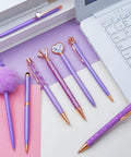 Purple Crystal Diamond Pens Set 8 Metal Pens In Different Styles With Black And Blue Ink For Journaling And Office Use For Women Glam Back To School Essentials And Girl Birthday Gift Idea on a desk with a laptop