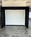 Complete Golf Practice Backdrop Enclosure Gear With Poles Corner Connectors Side And Top Netting Impact Screen And Carry Bag For A 10 Feet By 8 Feet Indoor Home Golf Setup in a room