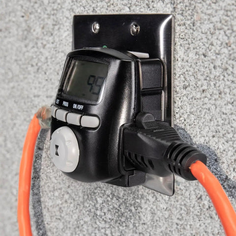 Digital Astronomic Landscape Timer With Precision Lighting Control plugged into wall outlet, showing display and connected cords.