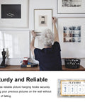 Person using the 117 Piece Picture Hanging Kit Featuring Heavy Duty Rock Steady Hooks Rated 30 50 And 100 Pounds for wall art.