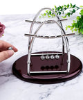 Newton Cradle Desk Toy With Clinking Pendulum Balls Calming Stress Relief For Home Office Decor Educational Gift shown on marble surface