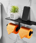 Double Roll Toilet Paper Holder With Shelf Matte Black Brass Finish, holding toilet rolls and items, wall-mounted in bathroom
