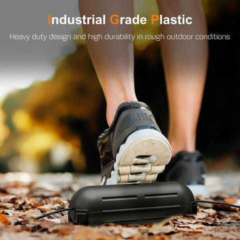 Close-up of Two Pack Waterproof Outdoor Extension Cord Cover Weatherproof Electrical Connection Box in black underfoot outdoors