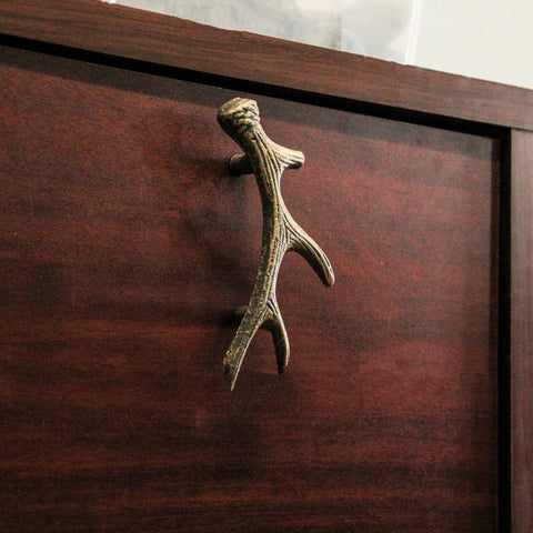 Antique Bronze Finish Cast Iron Deer Antler Drawer Pulls Set Of Six For Cabinets, installed on a wooden cabinet drawer.