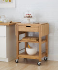 Premium Bamboo Extendable Rolling Kitchen Cart With Collapsible Drop Leaves And Deep Storage Drawer beside kitchen counter.