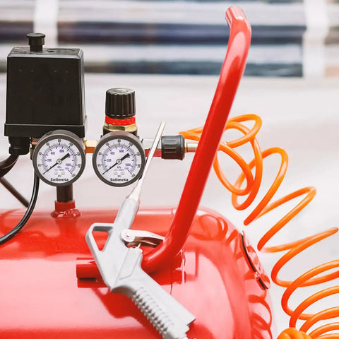 Close-up of air compressor with attached 2 Inch Dial Air Pressure Gauge For Air Compressors And Filters Center Back Mount Quarter Inch NPT 0 To 160 PSI Brass Internals Black Steel Case Pack Of Two