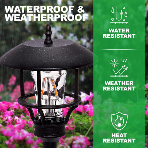 Close-up of a weatherproof vintage path light from the Low Voltage Outdoor Lights Set Modern Vintage Path Stake Lights And Spotlight Kit For Walkways Gardens And Lawns With Warm Glow And Cool Vibe Eco Friendly Weatherproof Landscape Lighting 8 Pack, surrounded by flowers.