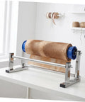 Hand Operated Unwinding Frame For Stretch Wrap Film Dispenser Tabletop Wrap Dispenser Machine Heavy Duty Metal And Plastic Construction Easy Winding And Lock Mechanism Ideal For Cargo Packing Moving And Packaging on white table
