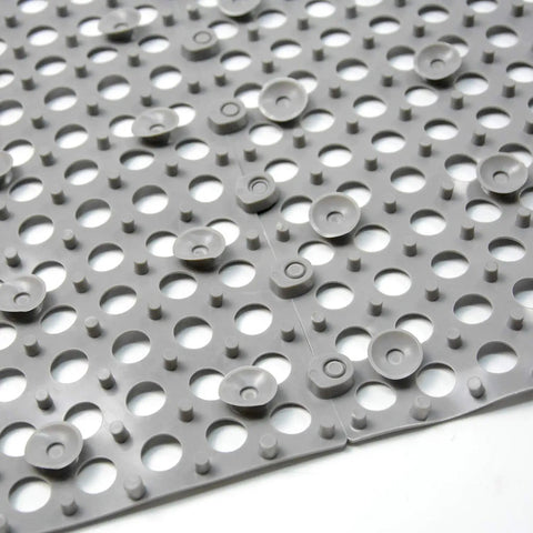 Close-up of 24 Pack Drainage Floor Mats With Interlocking Cushions, Non Slip PVC Mats, grey, holes and suction cups visible