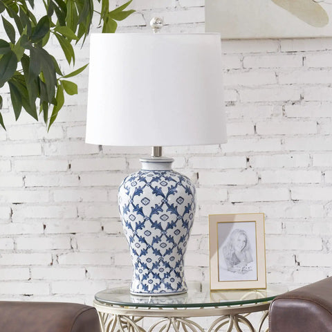 Blue Ceramic Table Lamp With White Fabric Shade Chinoiserie Urn Style Hand Painted Detail on glass table with plant