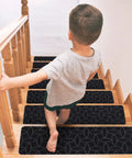 Child walking down wooden steps with 15 Piece Indoor Stair Treads For Wooden Steps Grippy Non Slip Carpet Treads With Gray Stripe Design Polyester Runner Mats For Safe Soft Foot Comfort And Easy DIY Stair Protection