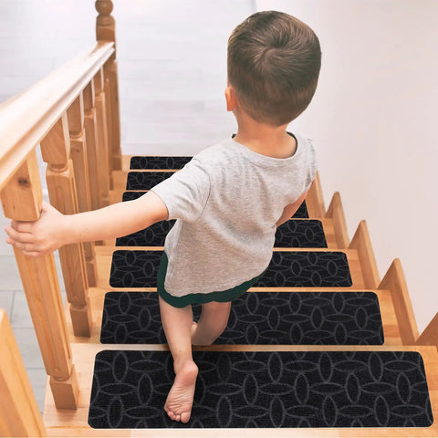 Child walking down wooden steps with 15 Piece Indoor Stair Treads For Wooden Steps Grippy Non Slip Carpet Treads With Gray Stripe Design Polyester Runner Mats For Safe Soft Foot Comfort And Easy DIY Stair Protection