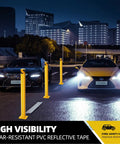 4 Pack 42 Inch Steel Safety Bollard Posts, Built Tough Heavy Duty Barrier, Bright Yellow High Visibility at night on a city street.