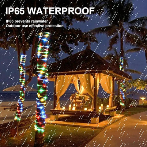 Solar Rope Lights 40 Ft 120 LEDs Multi Color Fairy Lights With 8 Modes illuminating palm trees and a gazebo in the rain