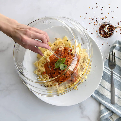 Hand lifting 10 Inch Plate Cover Dome Shield For Mess Free Cooking And Keeping Leftovers Hot on pasta with sauce, 3.1 inch high