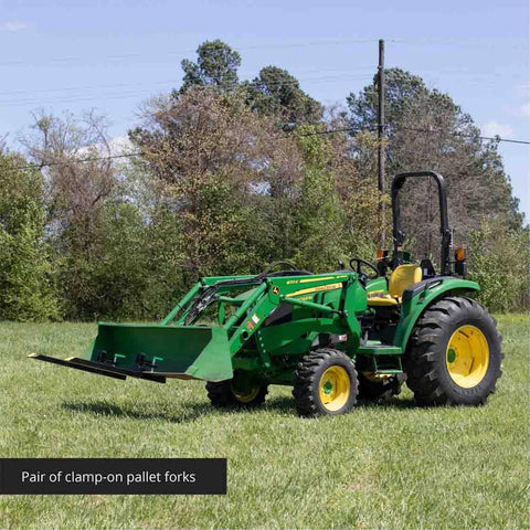 Light Duty Clamp On Pallet Forks, 43 Inch Overall Length on tractor in field, easy setup on loader for hauling