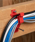 Lothee 200 Pack Red Cable Staples Clips With Steel Nails holding multiple cables securely against a wooden surface.