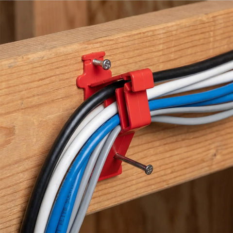 Lothee 200 Pack Red Cable Staples Clips With Steel Nails holding multiple cables securely against a wooden surface.