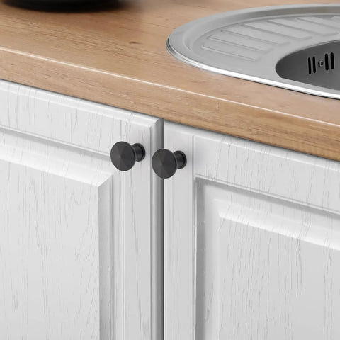 Matte Black Cabinet Knobs 10 Pack Solid Metal Sunburst Top Drawer Pulls For Kitchen Cabinets Bathrooms Vanities And Dressers Easy Single Hole Install For Modern Hardware Look on white kitchen cabinets next to wooden countertop and sink.