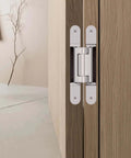 Concealed Door Hinge For Heavy Doors 3D Adjustable TECTUS TE 640 3D A8 240 Mm installed on wooden door, satin nickel look