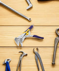 Pro Grade Heavy Duty Sheet Metal Clamp Pliers With Straight Jaw for precise bends on a wooden surface among tools