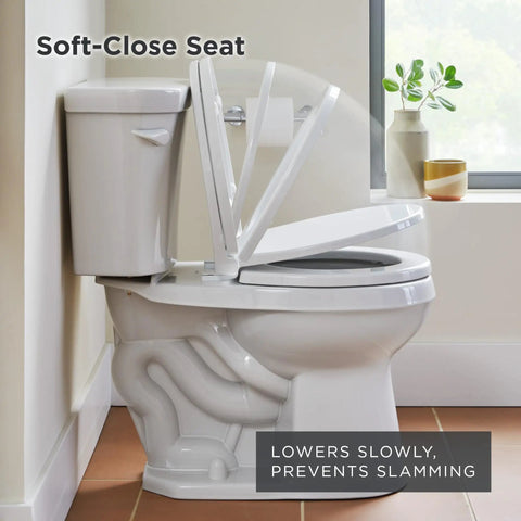 Round Bathroom Toilet Seat Built From Heavy Duty Plastic With Smooth Operator Soft Close Hinges And Nonslip Bumpers Delivering A No Slap Performance That Seals The Deal On Comfort And Style Daily, positioned beside a tank.