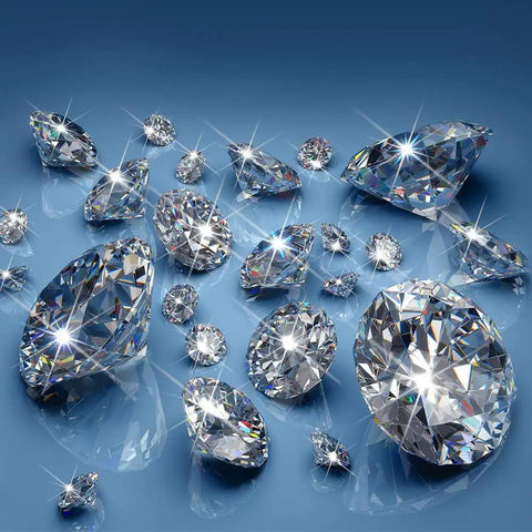 Various sparkling crystals on a blue surface, illustrating elements of the Bling Silver Rhinestone Light Switch Cover Plate With Sparkling Crystal Accent Shiny Wall Plate Cover For Living Room Bedroom Decor Easy Install Premium Plastic Single Pack.