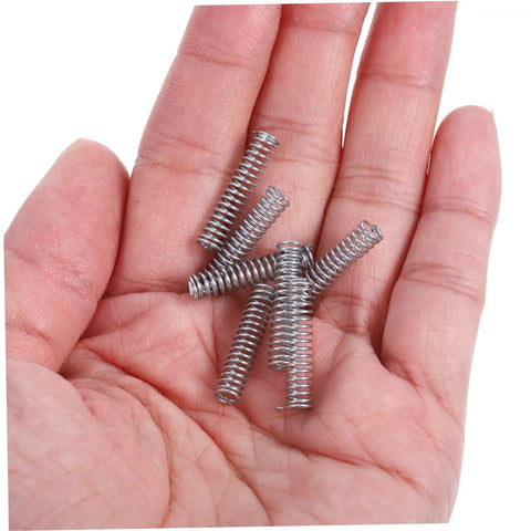 Top Quality 100 Pieces Mini Stainless Steel Compression Springs Assortment Kit For Cool DIY Repairs And Varying Mechanical Projects Perfect To Fix Stuff At Home Or In The Garage With Ease. Mini stainless steel springs in hand