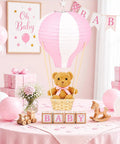 Bear Themed Hot Air Balloon Centerpiece Kit For Baby Shower And Gender Reveal With 6 Pink Paper Lanterns displayed on baby shower table.
