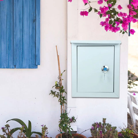Tough As Nails Outdoor Waterproof Junction Box For Low Voltage Circuits installed on outdoor wall next to blue window