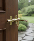 Rock Solid Slide Bolt Gate Latch Rust Proof Galvanized Steel Hardware With Tight Strike Plate For Outdoor Barn Shed Door Lockdown Guard And No Sweat Weather Shielding on a wooden door with raindrops.