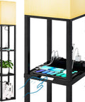 Slim black three tier floor lamp with shelves, USB ports, power outlet, and LED bulb, showing plant and books, modern lighting.