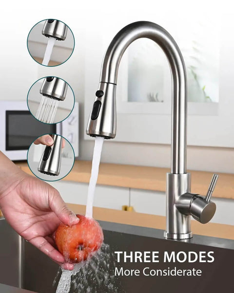 Pull Down Sprayer Kitchen Faucet In Brushed Nickel High Arc Design with a hand washing fruit, three spray modes visible