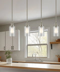 Brentwood Seeded Glass Shades Set hanging in modern kitchen, clear bubble glass, 6.25x4 inch, fits 1-5/8 inch fitter, 3-pack replacements.