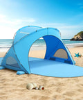 Blue Beach Shade Tent With UPF50 UV Protection for 1 to 3 people, set up on sandy beach with ocean view and scattered seashells.