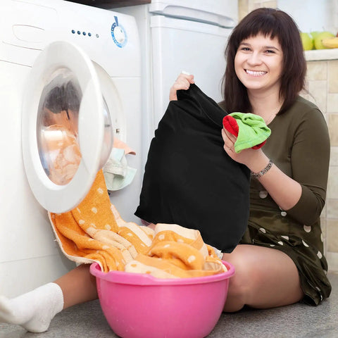 Person holding Two Pack Large Travel Laundry Bags Waterproof Wet Dry Bag near washing machine and laundry basket