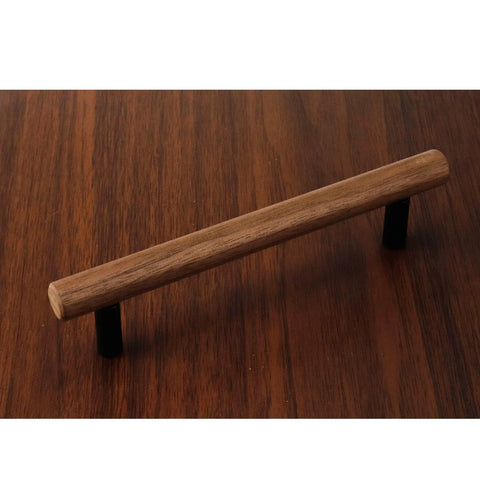 Walnut wood drawer pull with metal base, 5.04-inch hole centers, shown on wooden surface, ideal black dresser hardware with screws.
