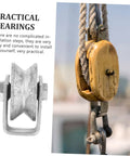 Cast iron V-type groove wheel garage door roller, rigid caster; silver wheel with bolts beside a wooden pulley block.