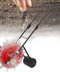 Metal Garden Seeder With 12 Seed Outlets Walk Behind Precision Planter in a garden next to hand planting seeds in soil.