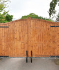 Wooden double gate with Beefed Up Heavy Duty Gate Wheel With Spring Loaded 4.3 Inch Gate Caster for Outdoor Fences and Farm Gates installed.