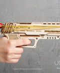 Wooden Wolf 01 Handgun 3D Puzzle rubber band gun model in hands, side view with bands loaded